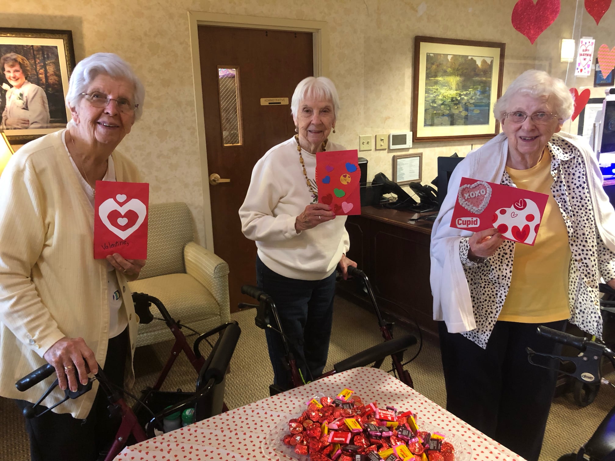 Three ladies with Valentine Cards at senior living. 