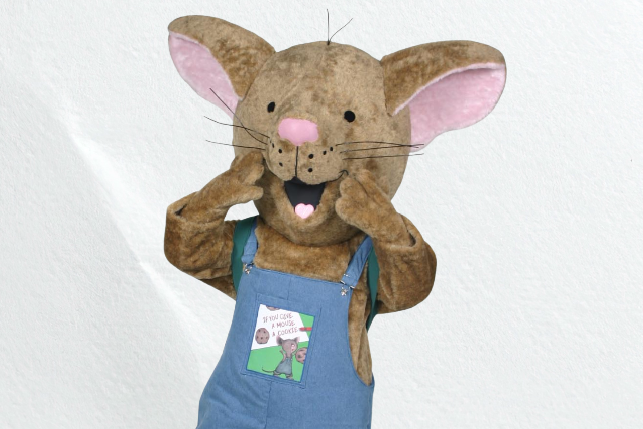 A large mouse costume wearing overalls with a shocked look on its face.
