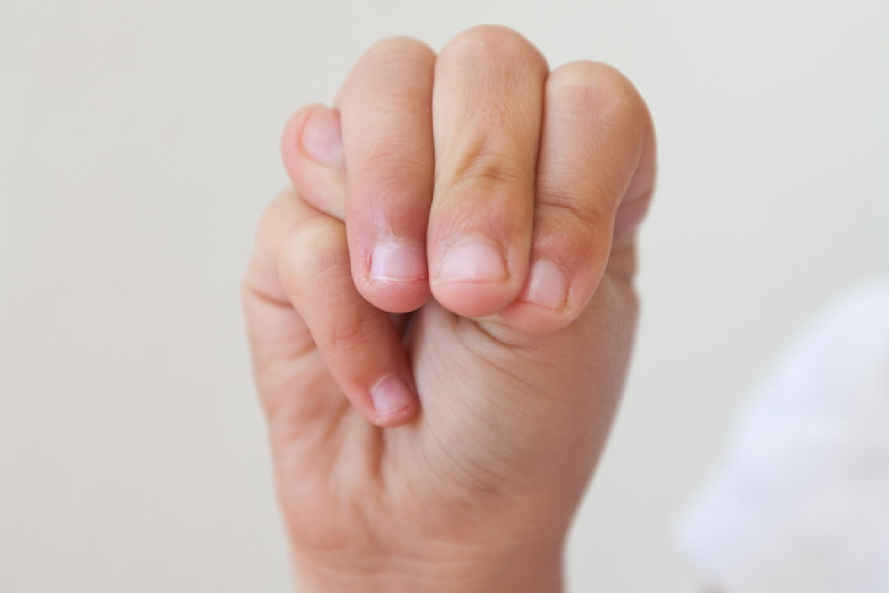 Hand doing the sign language symbol for the letter 'M'