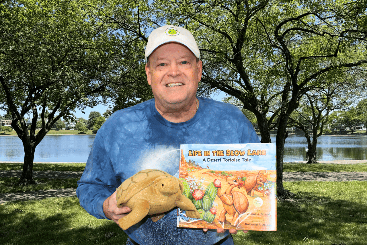 Conrad Storad holding book and turtle puppet