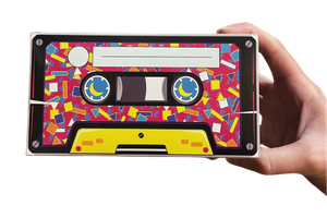 Pink, yellow, and black retro styled mystery box that is being held by a hand.